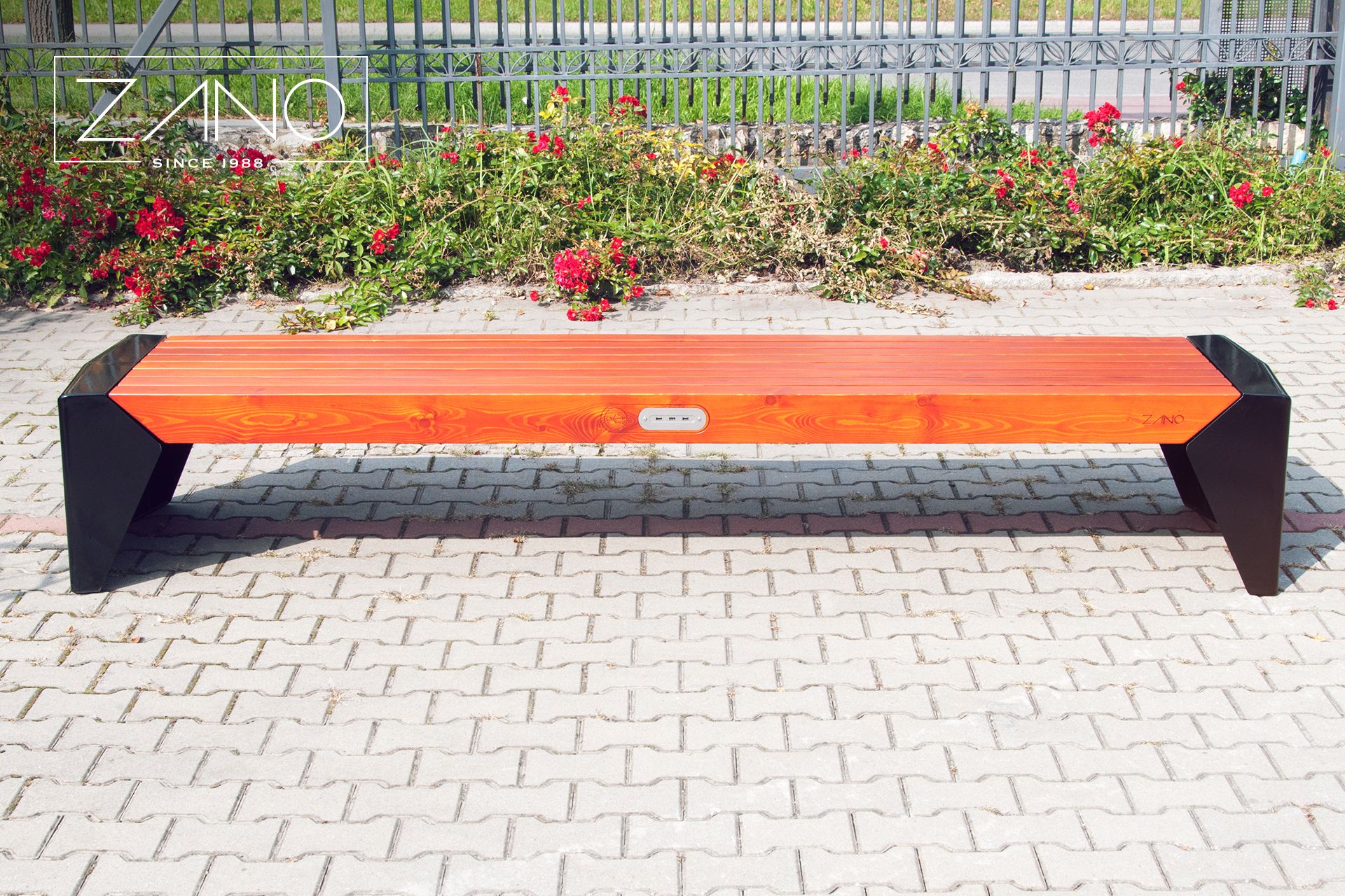 Urban bench with USB panel for charging mobile devices